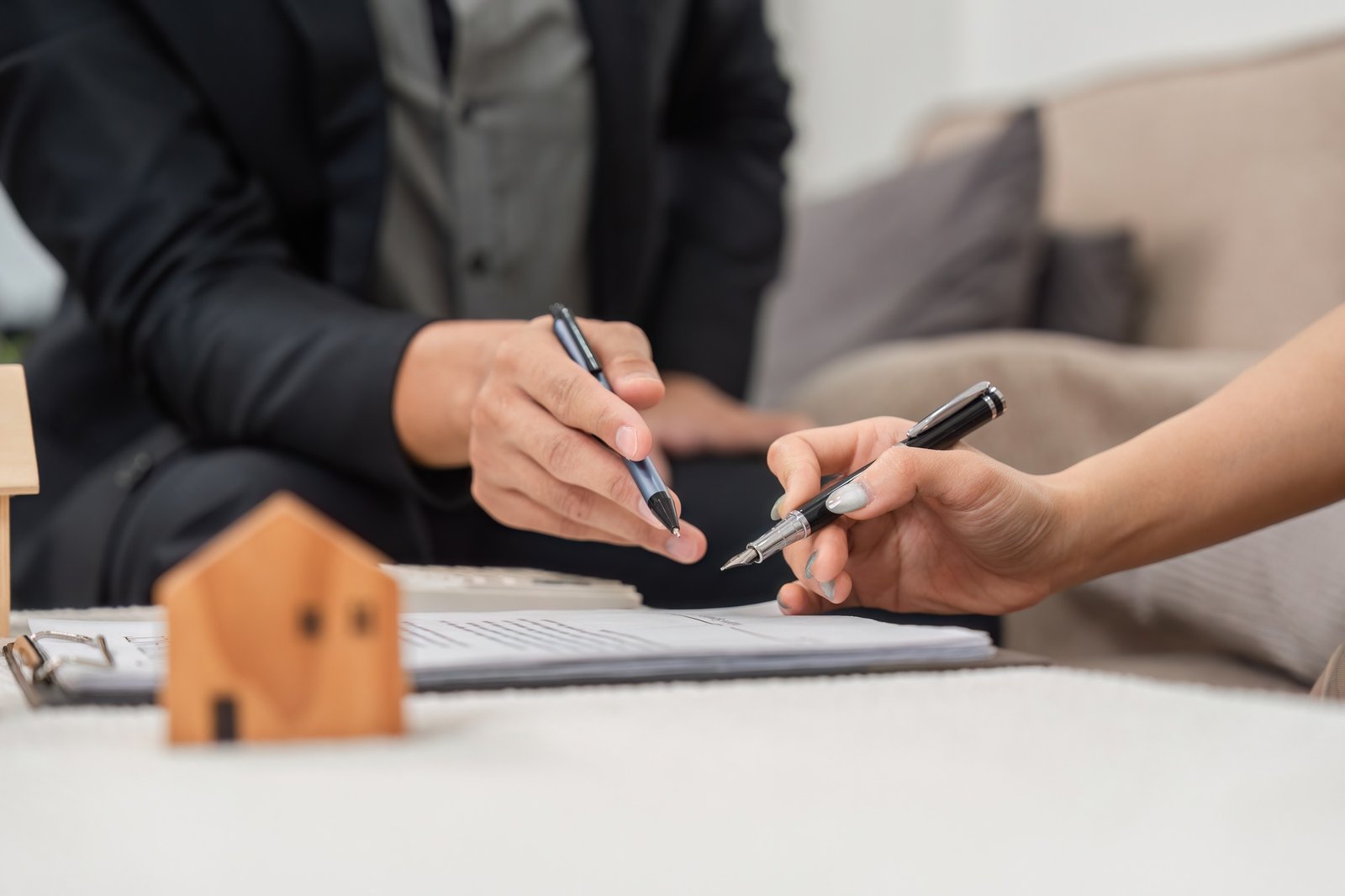 Real Estate Planning. Individuals negotiating terms of property agreement with documents